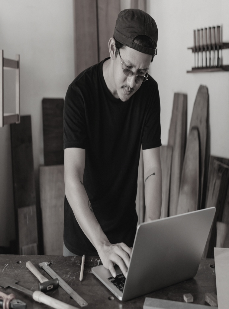 Business owner using a laptop at his workshop
